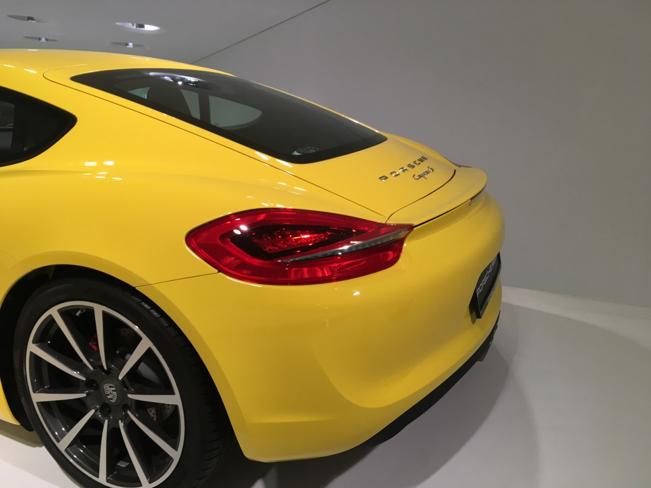 Yellow sports coupe rear with taillight and alloy wheel