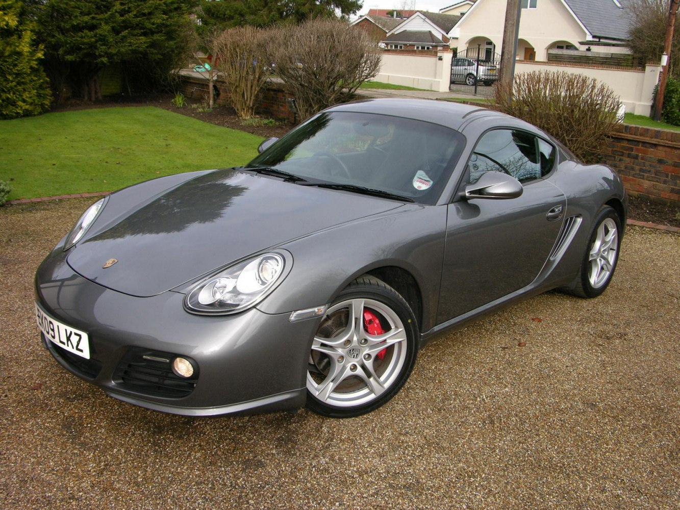 Front angle of sporty coupe with alloy wheels and red brake calipers