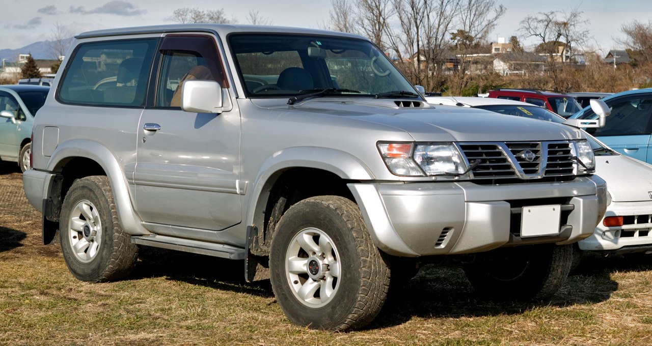 Front side view of rugged off-road SUV with high clearance and durable tires