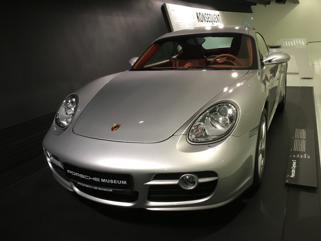 Silver sports coupe with sleek front and oval headlights