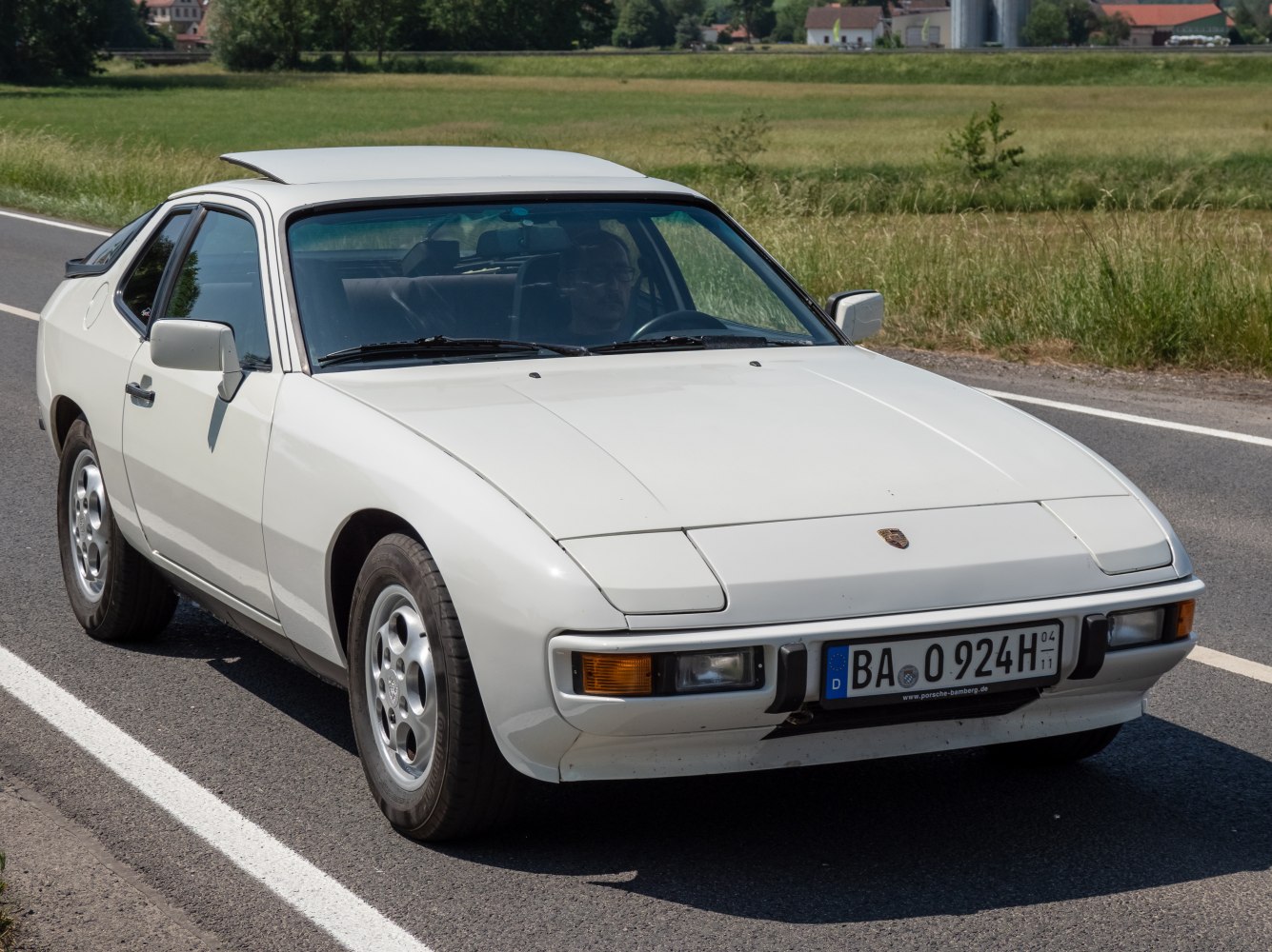 Front view of a coupe with pop-up headlights and aerodynamic hood.