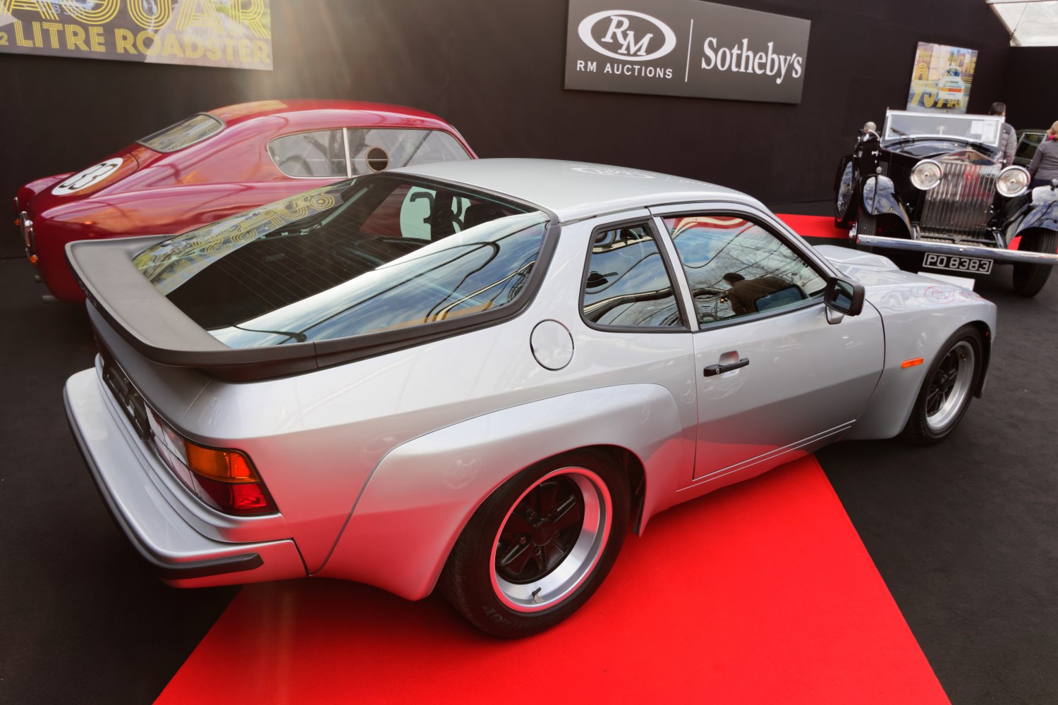 Silver sports coupe with rear spoiler and sloped rear window
