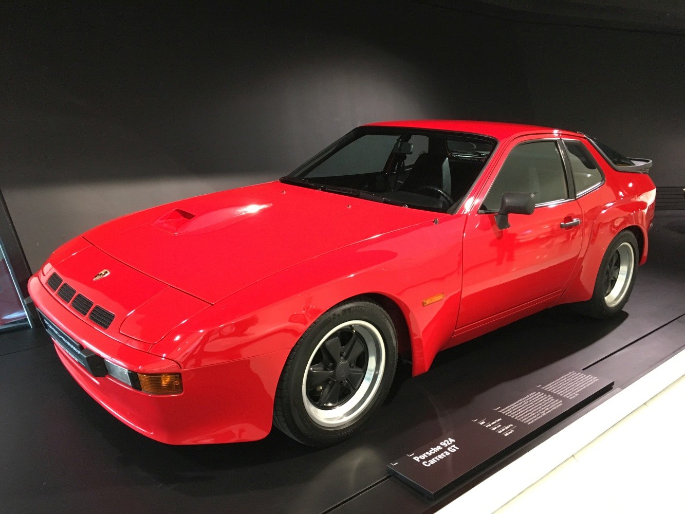 Red sports coupe with flared wheel arches and rear spoiler