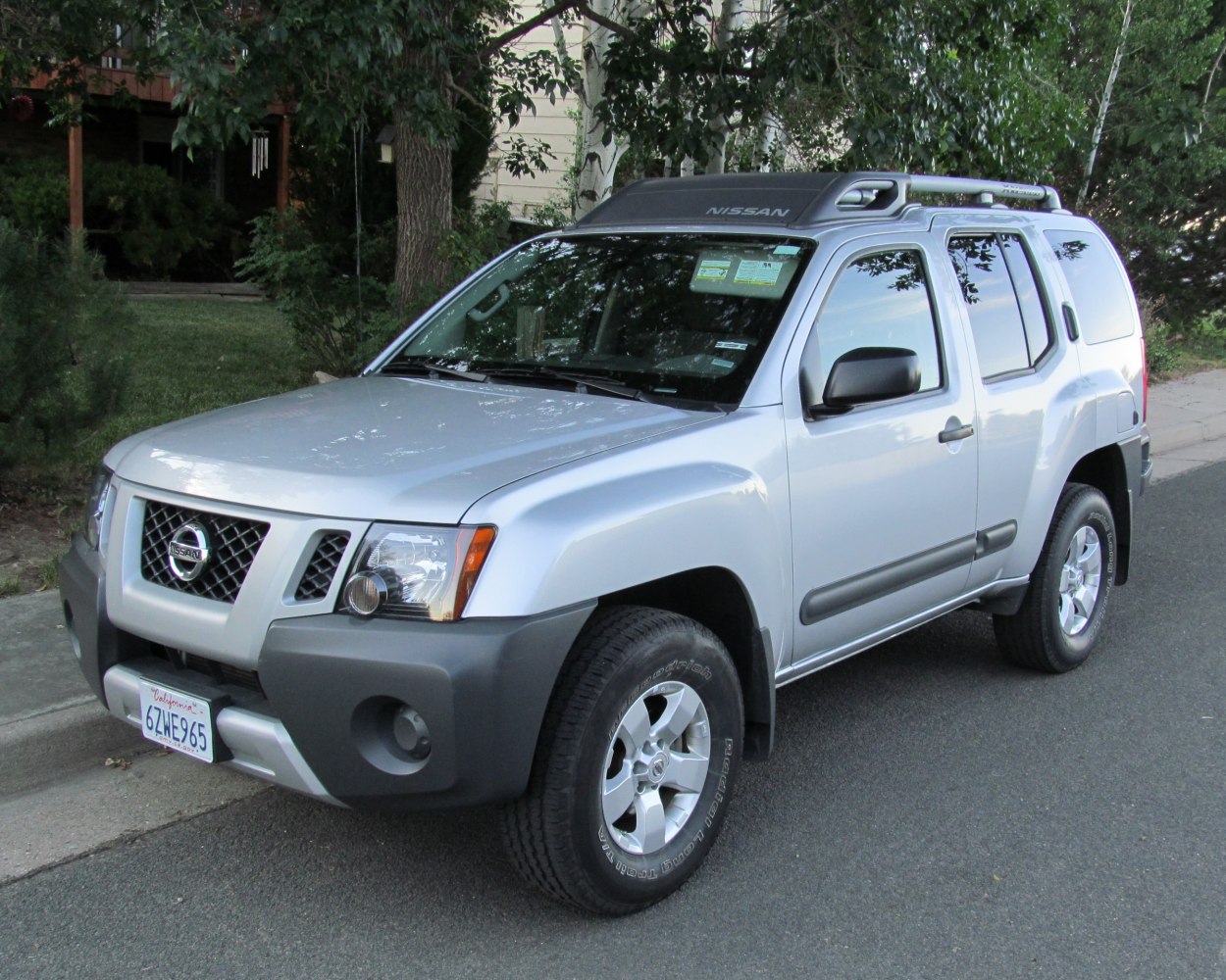 SUV with roof rack and front underguard in silver color.