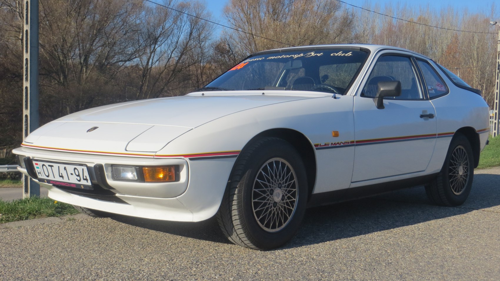 Porsche 924 coupe front-side view with pop-up headlights and Le Mans racing stripe