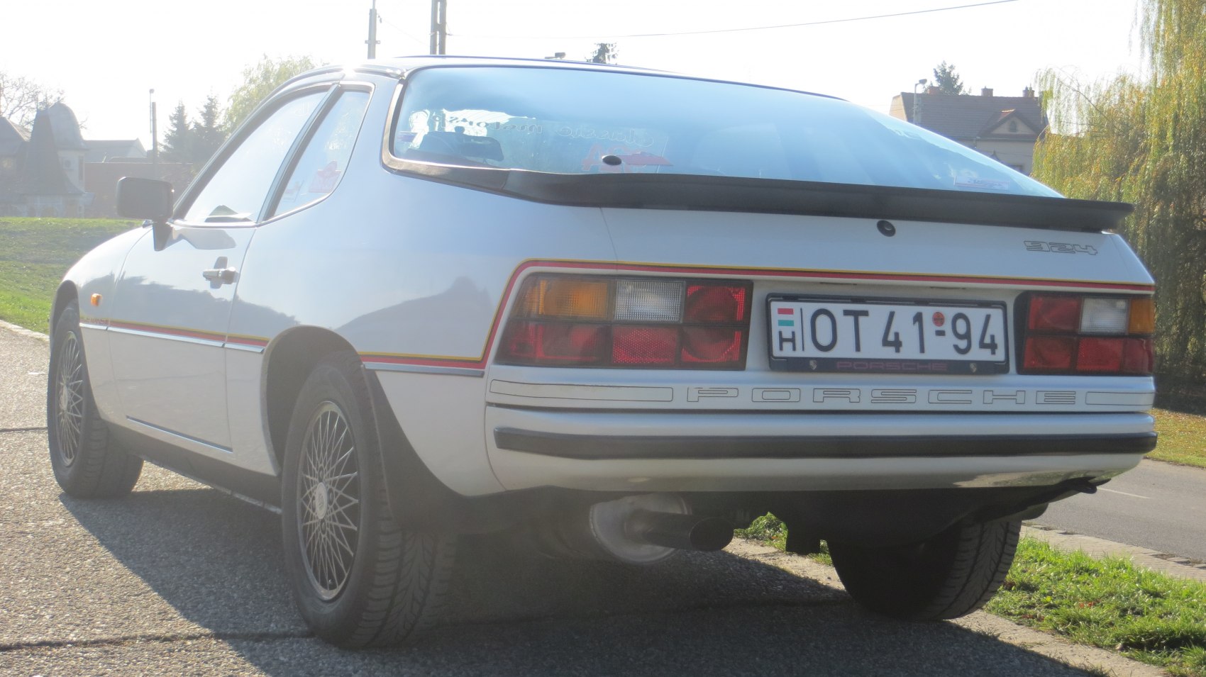 Rear view with prominent tail lights and rear spoiler