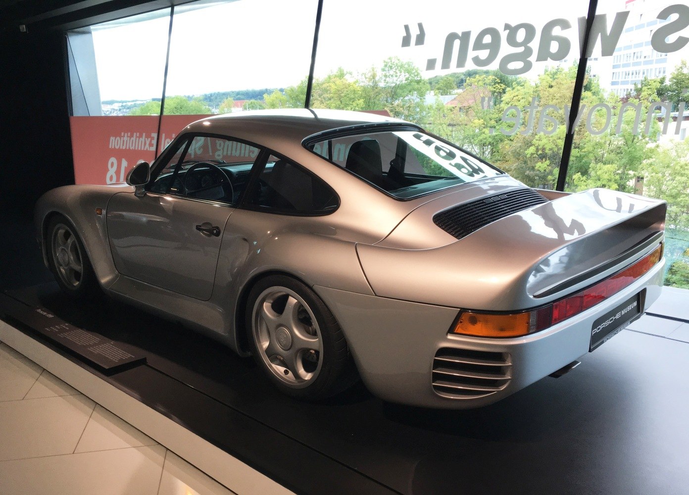 Rear side view with prominent rear spoiler and smooth aerodynamic curves.