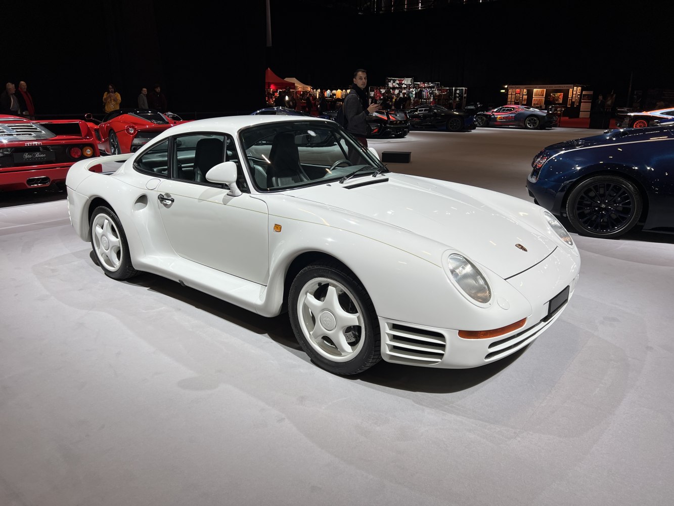 White 1987 Porsche 959 sports coupe with distinct aerodynamic body and unique wheels