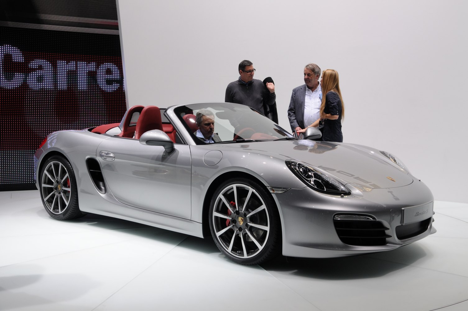 Silver convertible with red leather interior and multi-spoke alloy wheels