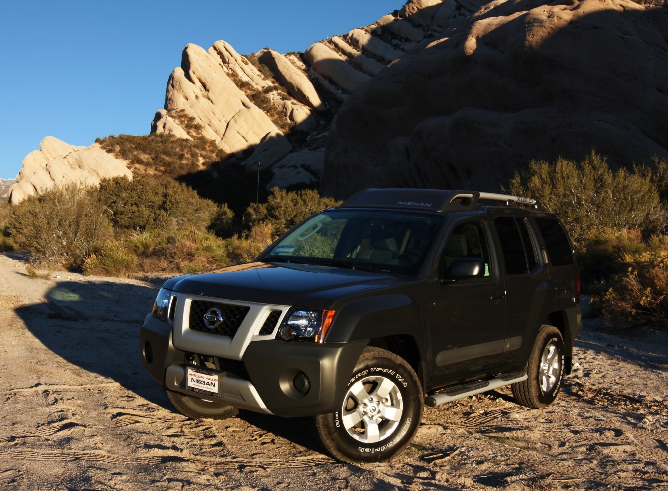 Rugged off-road SUV parked in a rocky desert landscape.