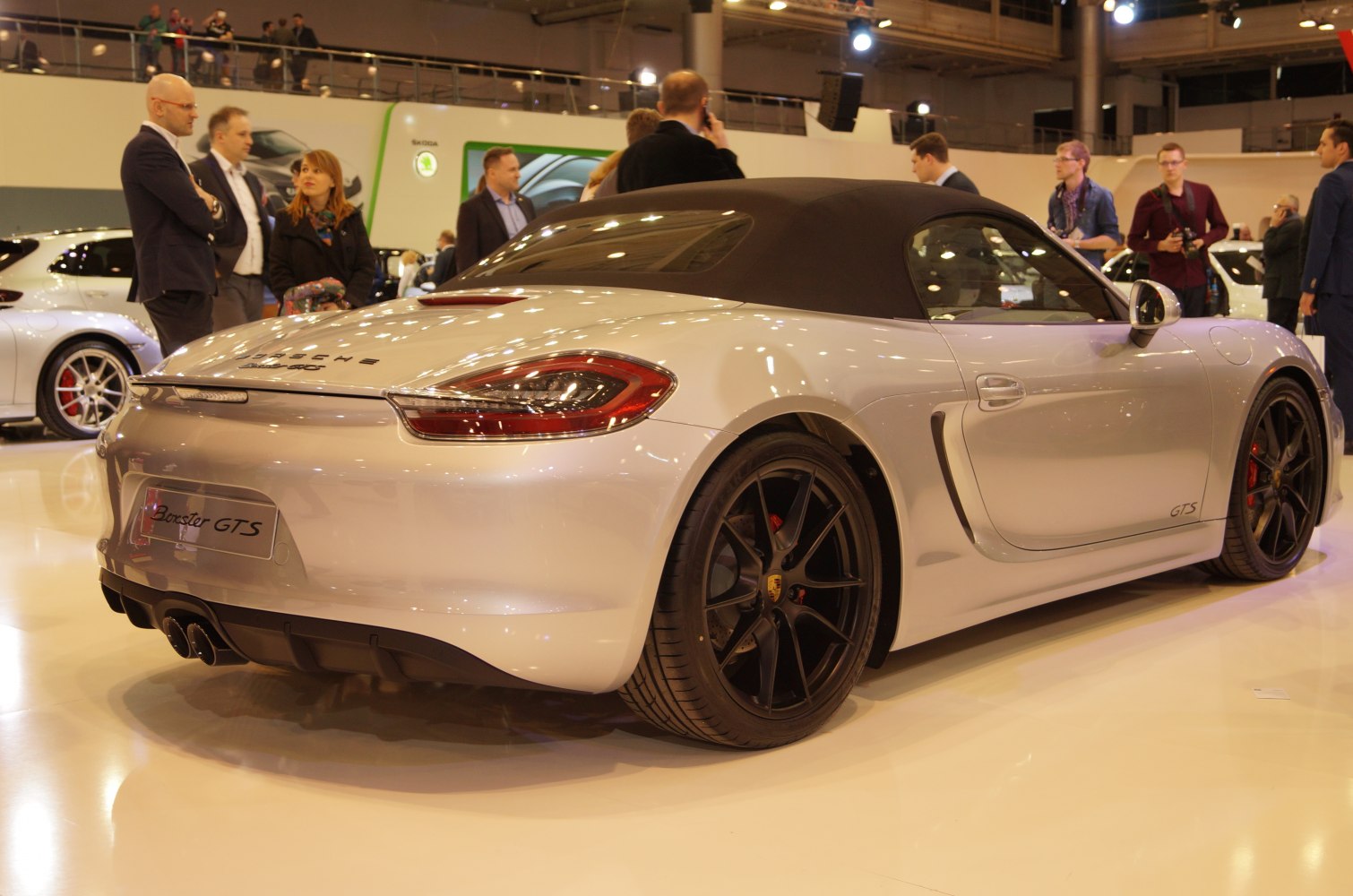 Rear view of a convertible with black alloy wheels and dual exhaust tips.
