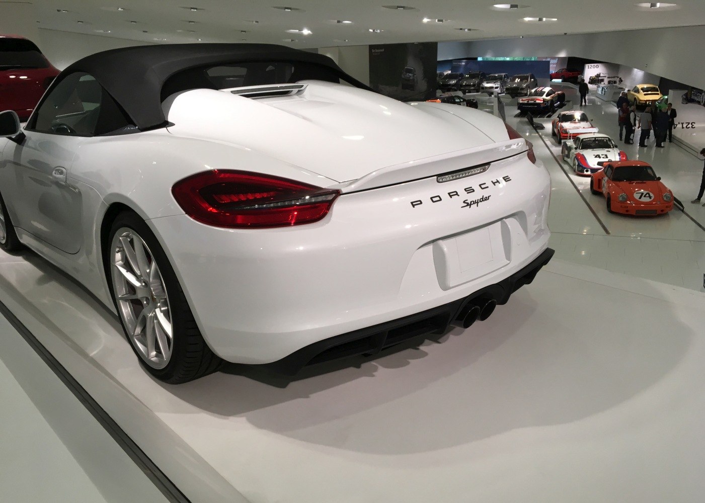 Rear close-up of a convertible with distinct tail lights and dual exhausts