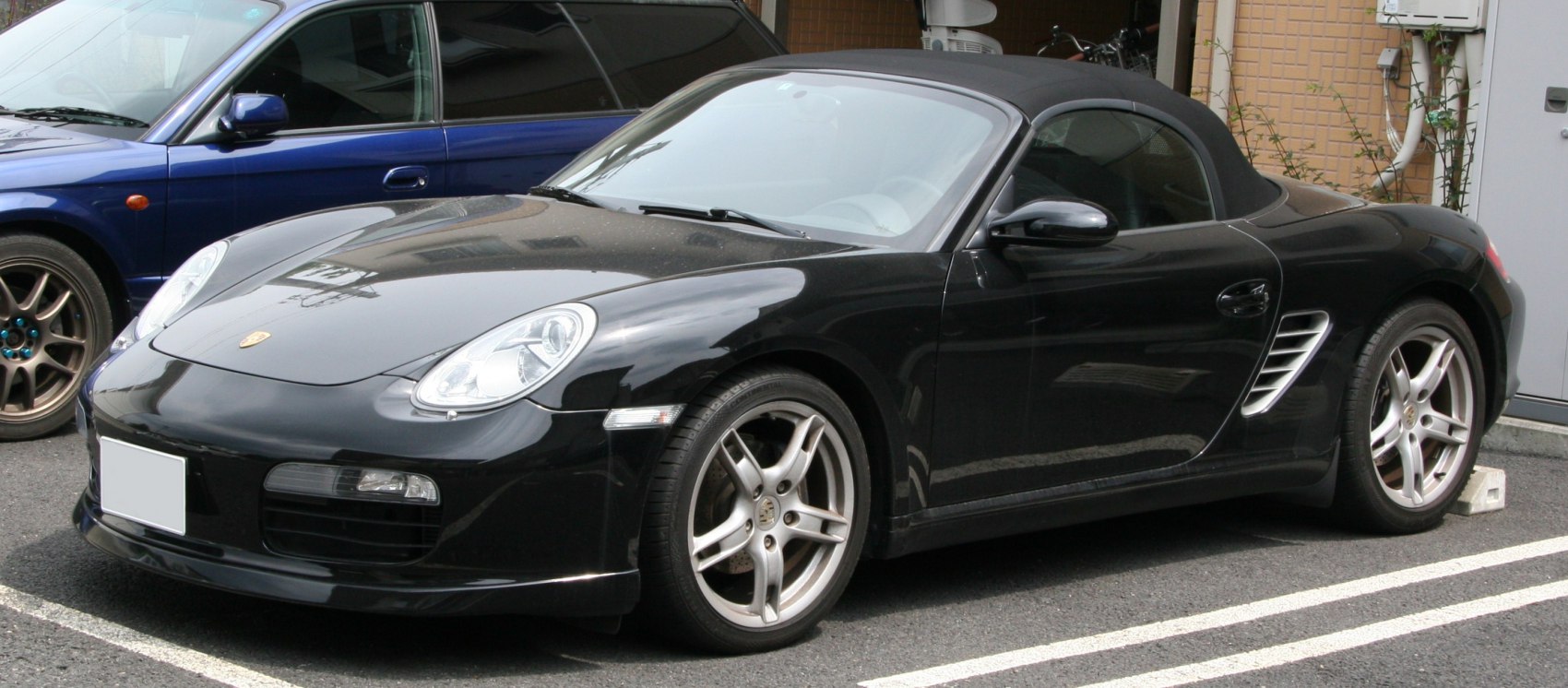 Black convertible sports roadster with aerodynamic body and alloy wheels