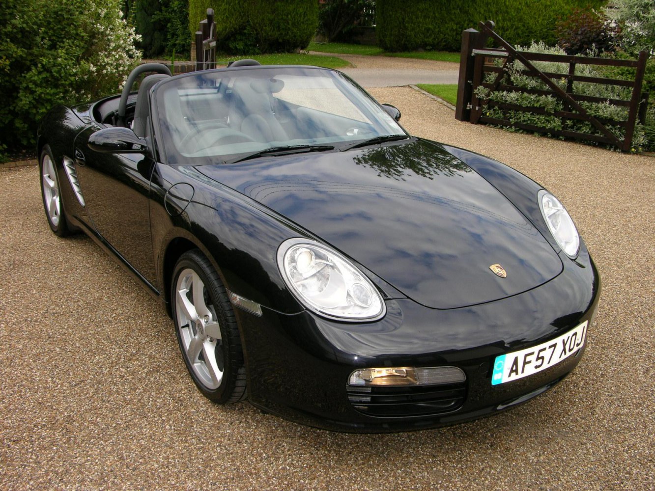 Black convertible sports car with distinctive headlights and sleek aerodynamic design.