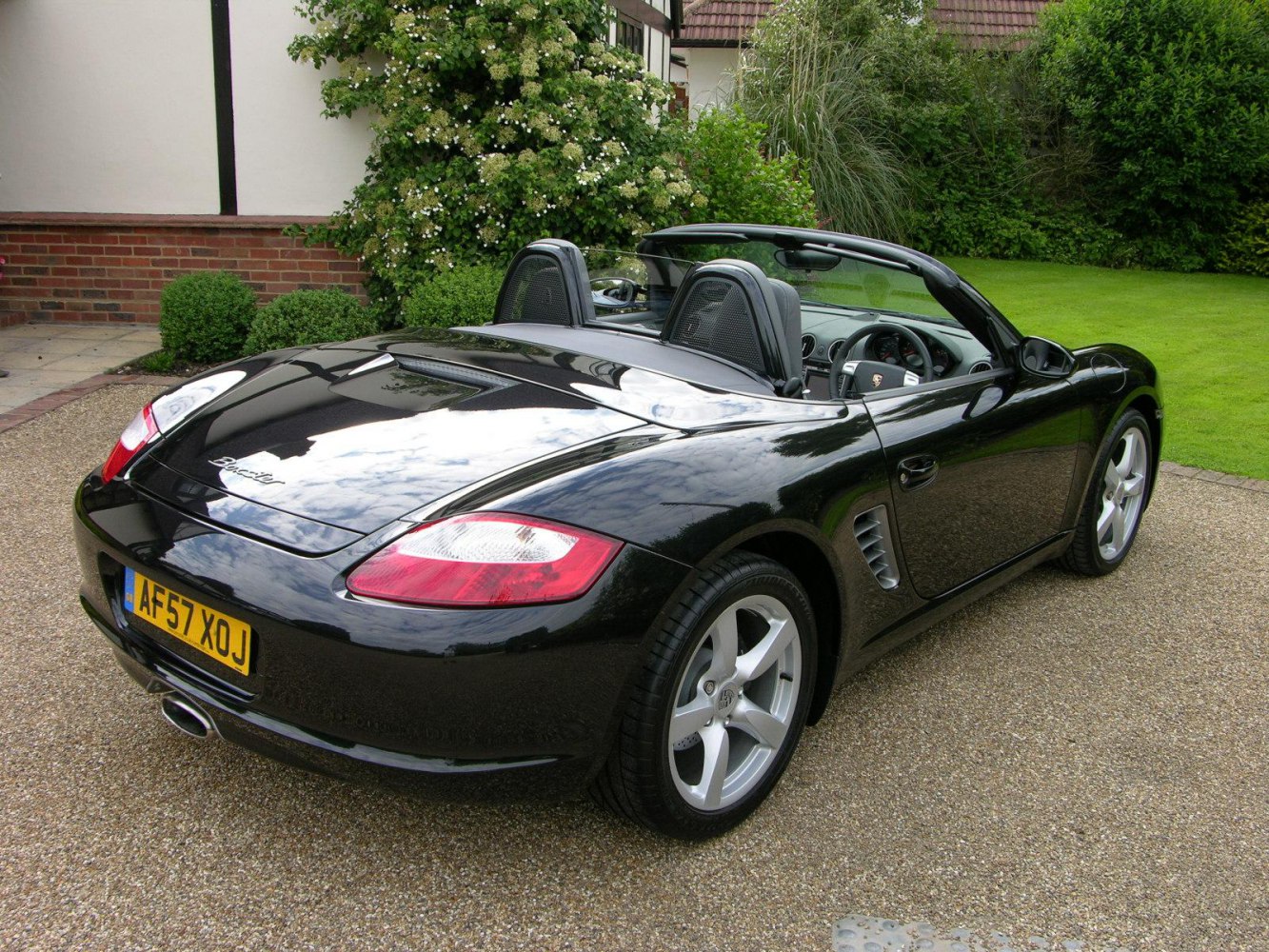 Black convertible rear and side view with air vents and alloy wheels