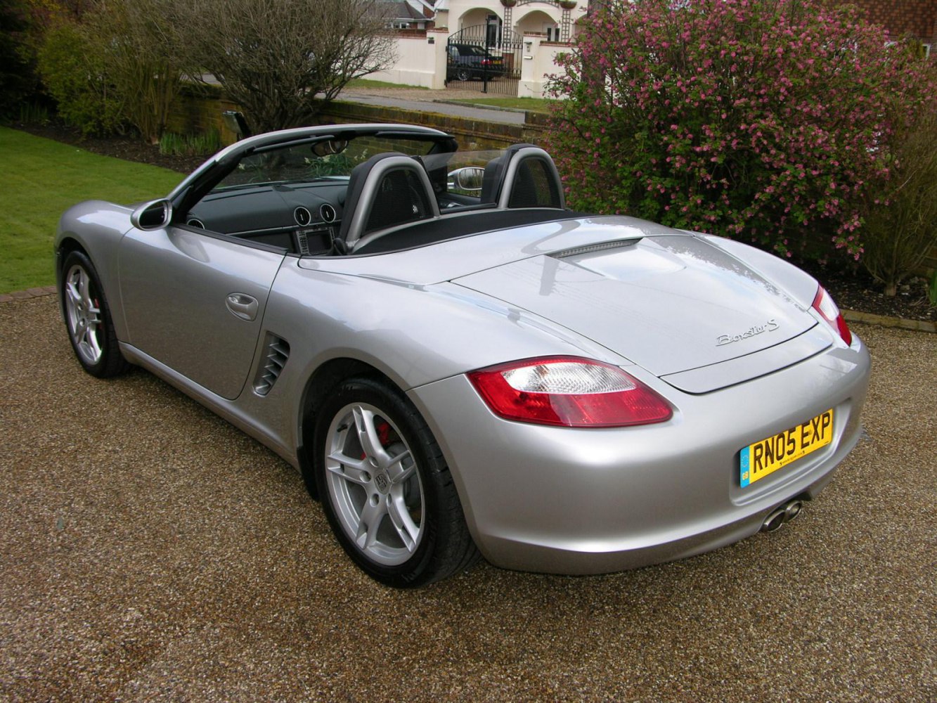 Silver convertible rear side with tail lights and dual exhaust