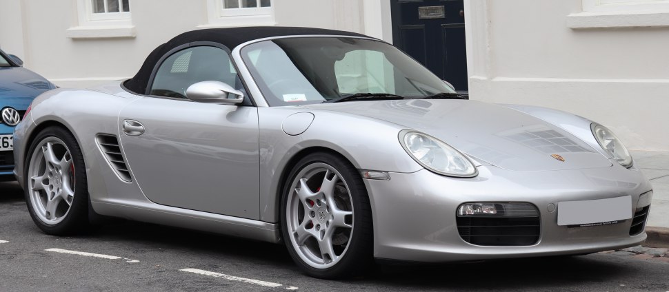 Silver convertible sports car with soft top and side air intakes