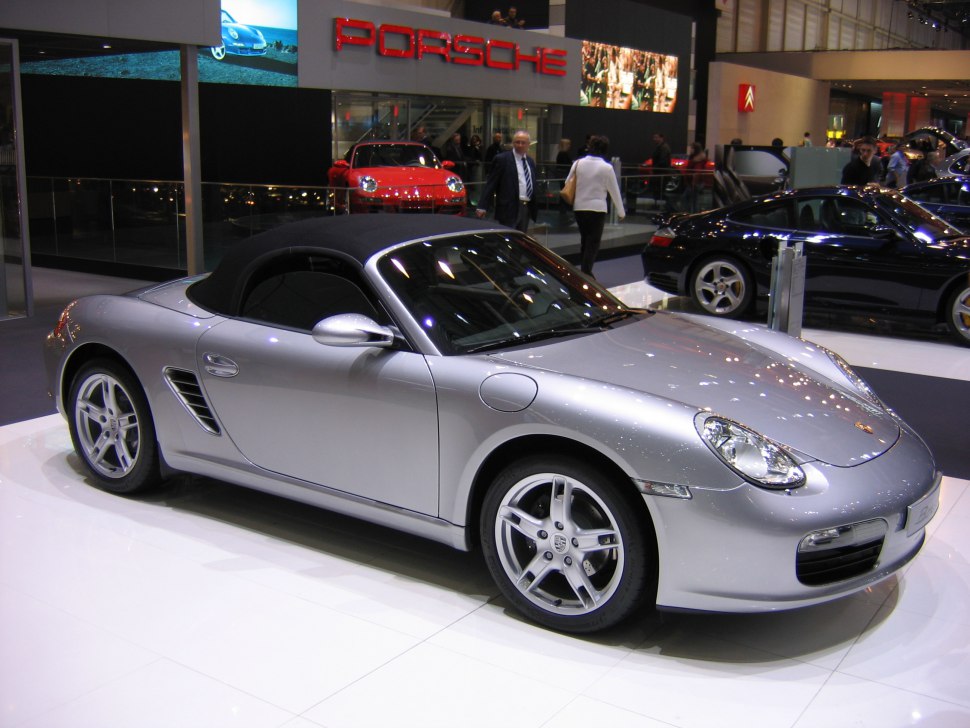 Silver convertible roadster with black soft top and alloy wheels