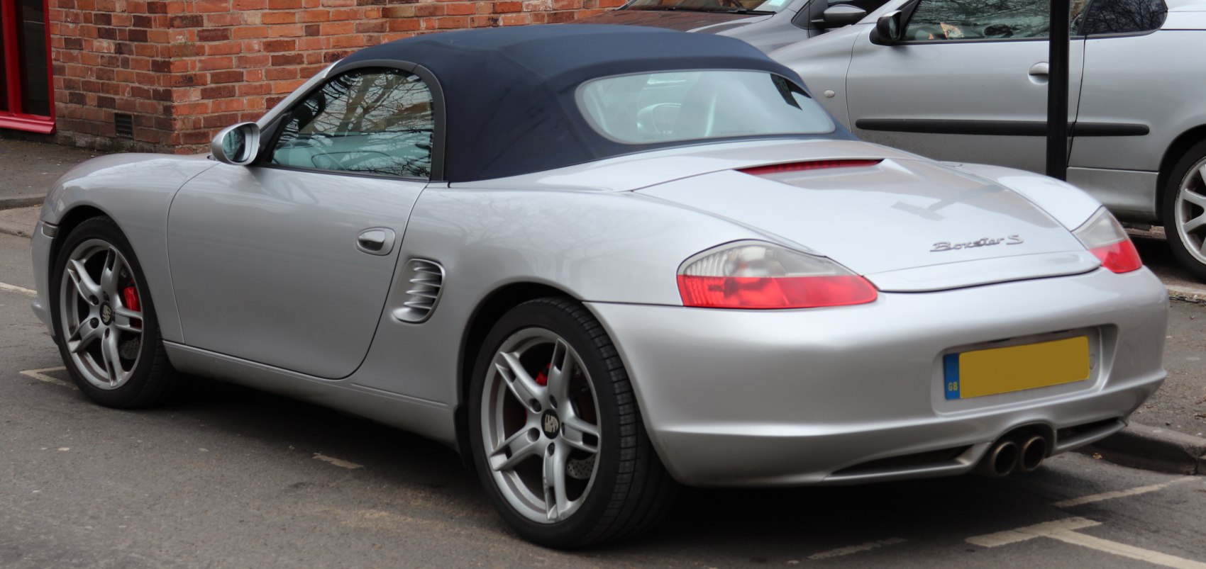 Rear angle of convertible with soft top and dual exhaust