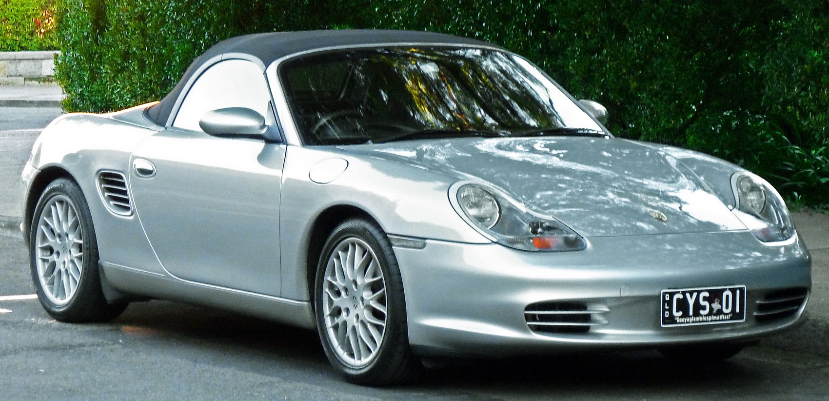 Silver convertible roadster with unique headlights and alloy wheels