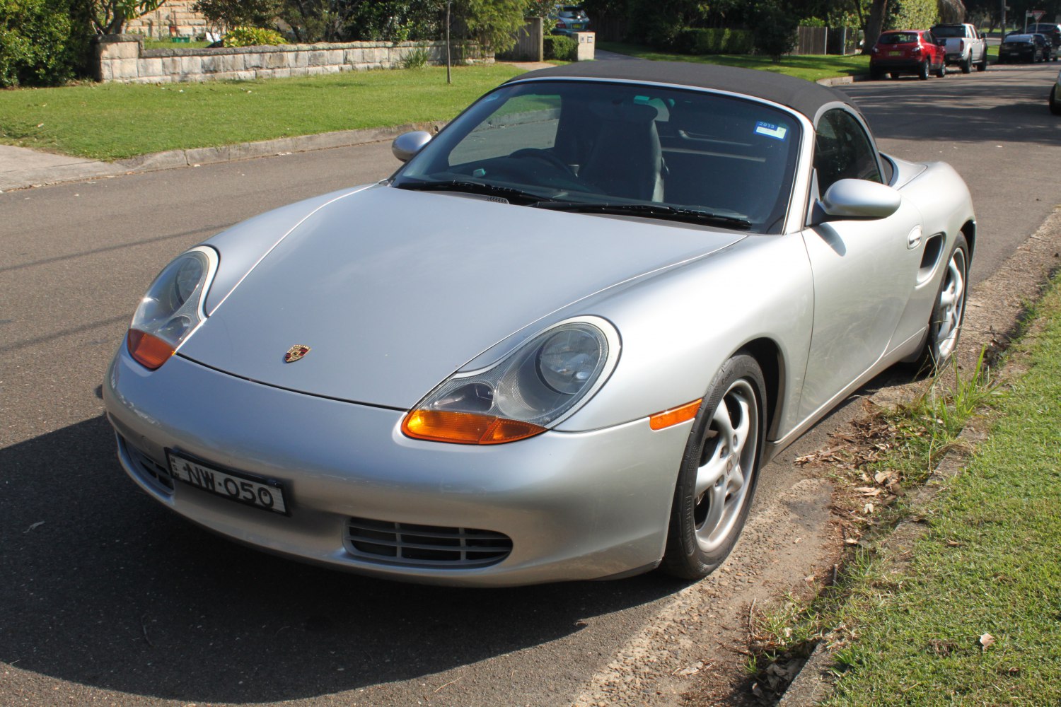 Convertible sports car with rounded headlights and soft top roof