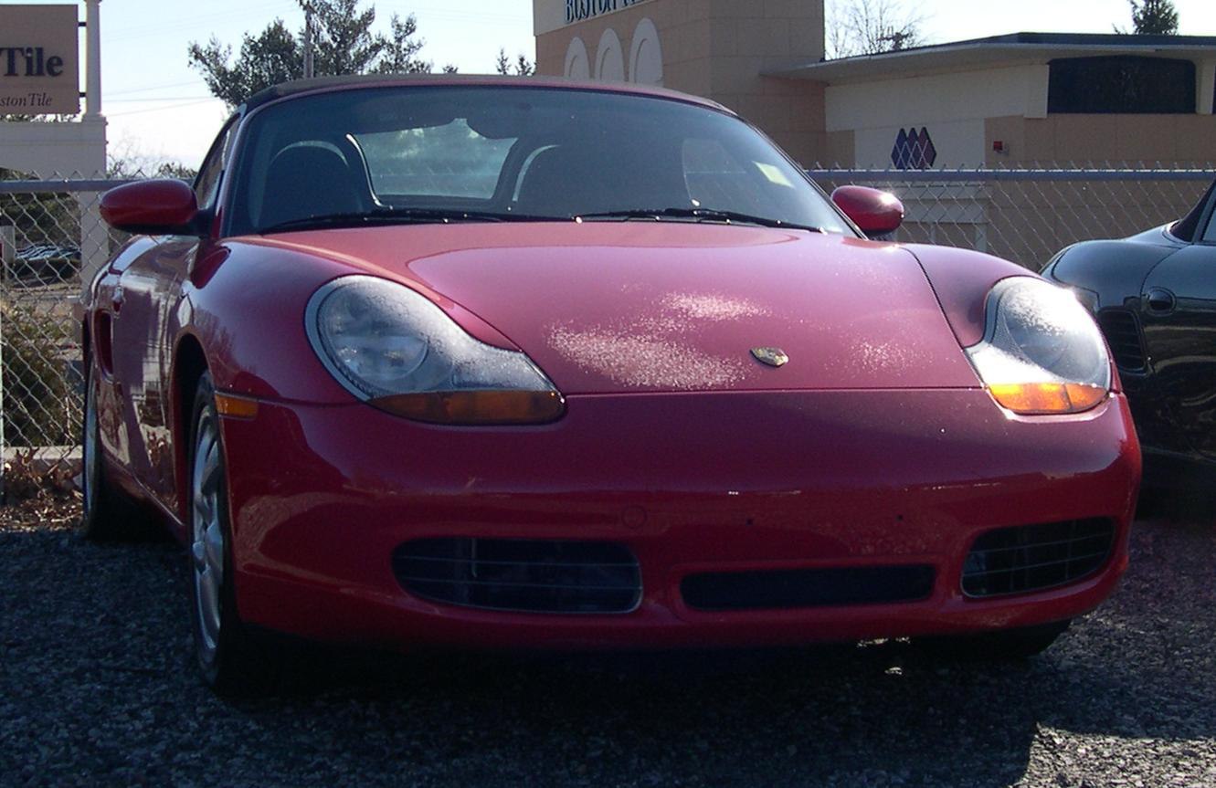 Front view with rounded headlights of a red sports coupe