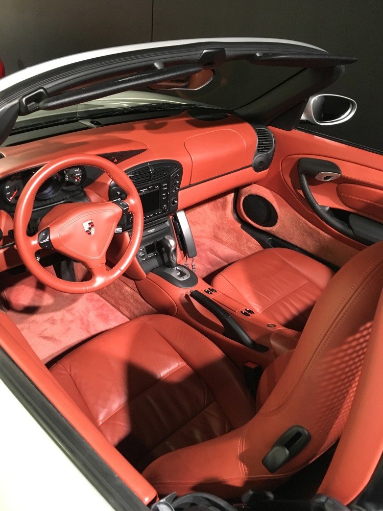Red leather interior with dashboard, steering wheel, seats