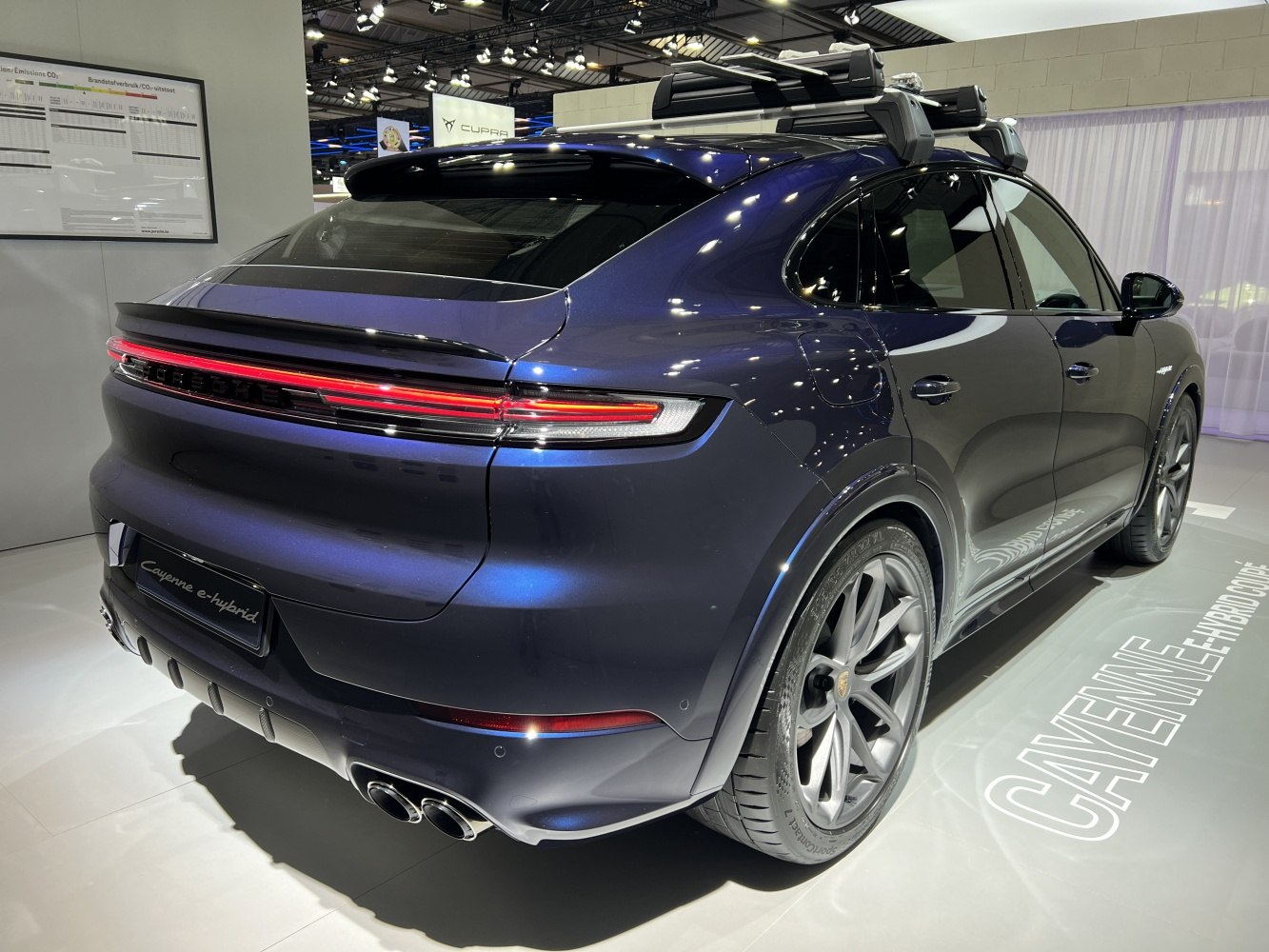 Rear view with LED taillights and roof rack of a sleek SUV coupe.