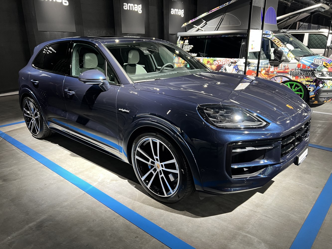 Front and side view of a hybrid luxury SUV with distinct headlights
