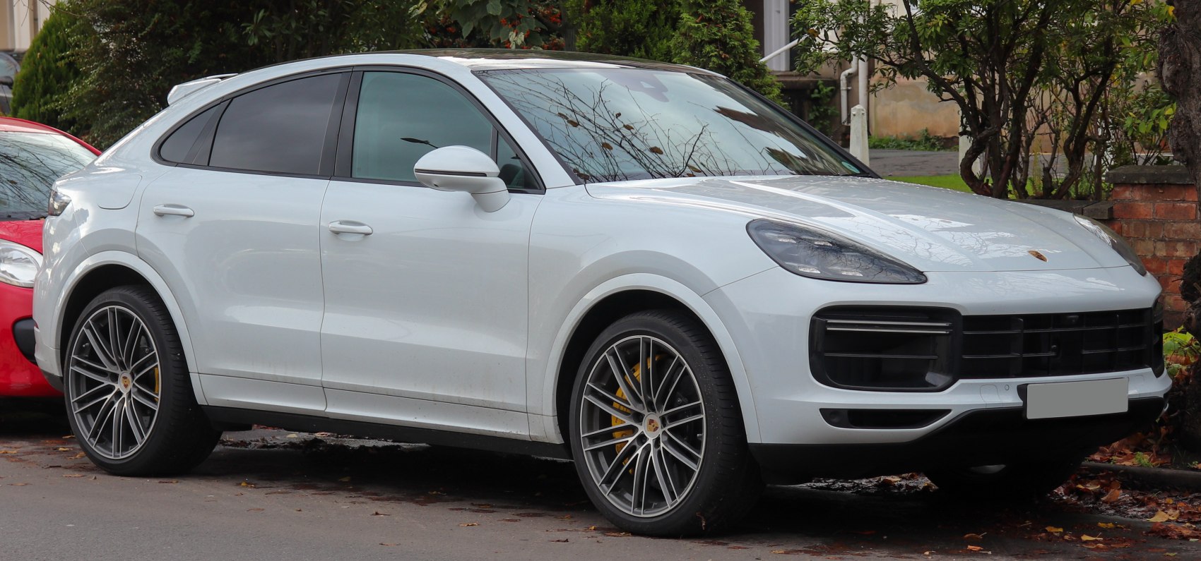 Luxury white SUV with multi-spoke alloy wheels and large side windows
