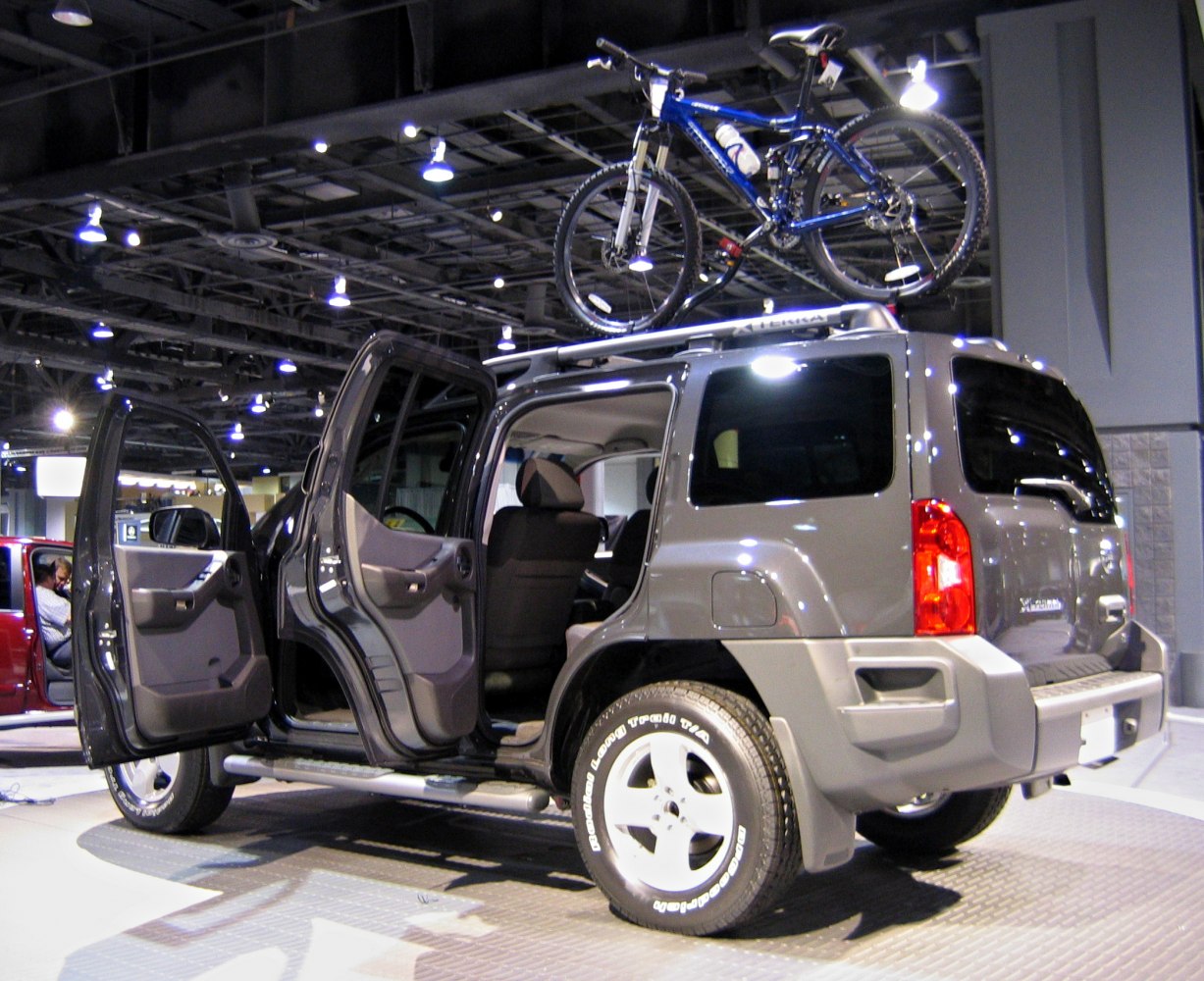 SUV with open doors and a roof-mounted mountain bike