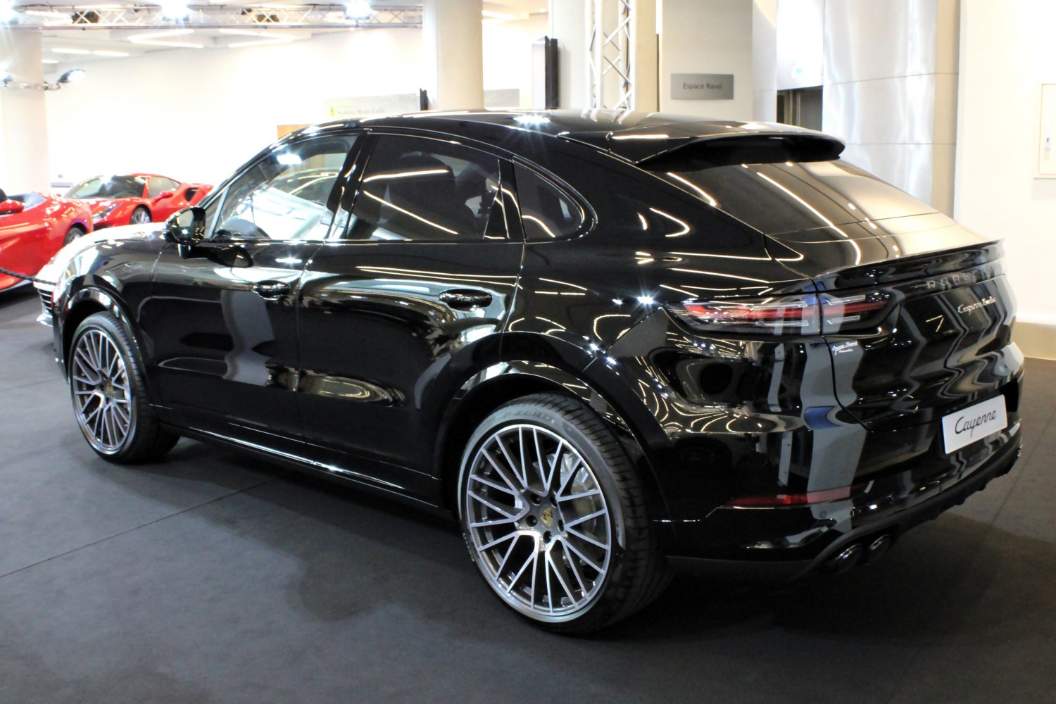 Black luxury SUV coupe with sloping roofline and multi-spoke alloy wheels
