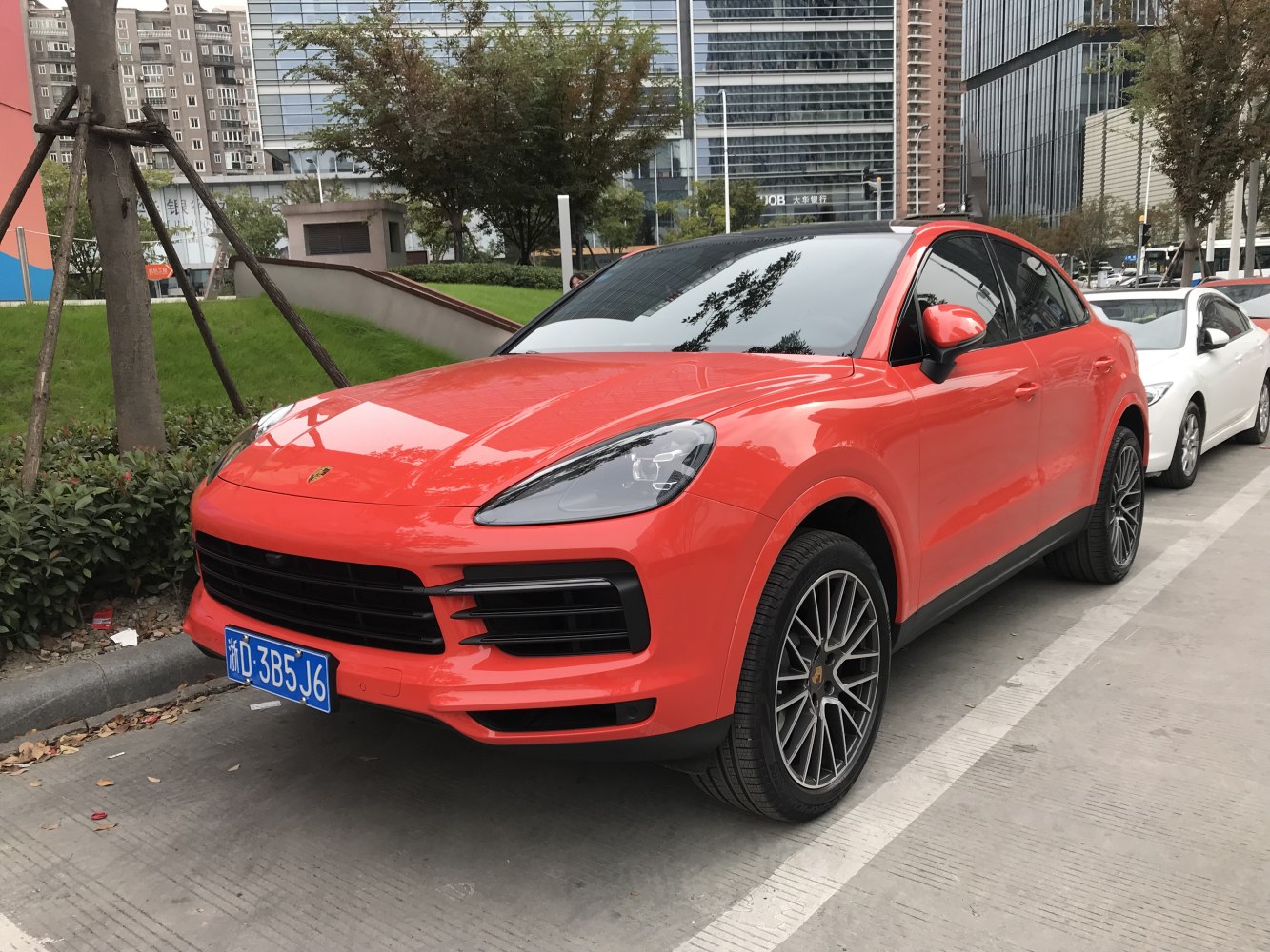 Red SUV with modern grille and sporty alloy wheels.