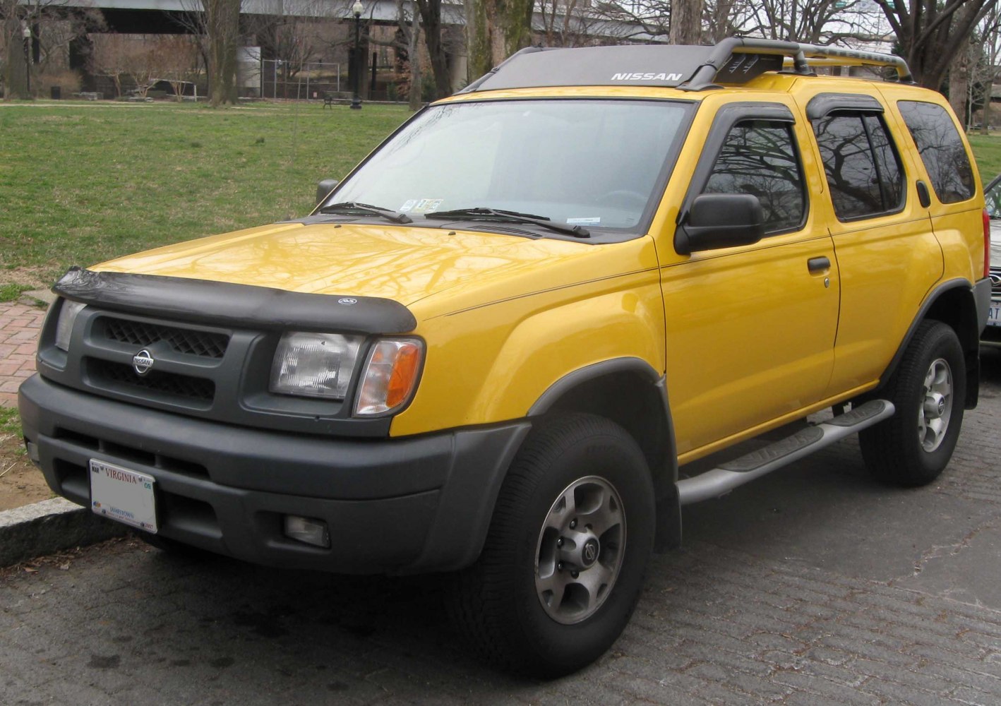 Yellow SUV with roof rack and bug deflector