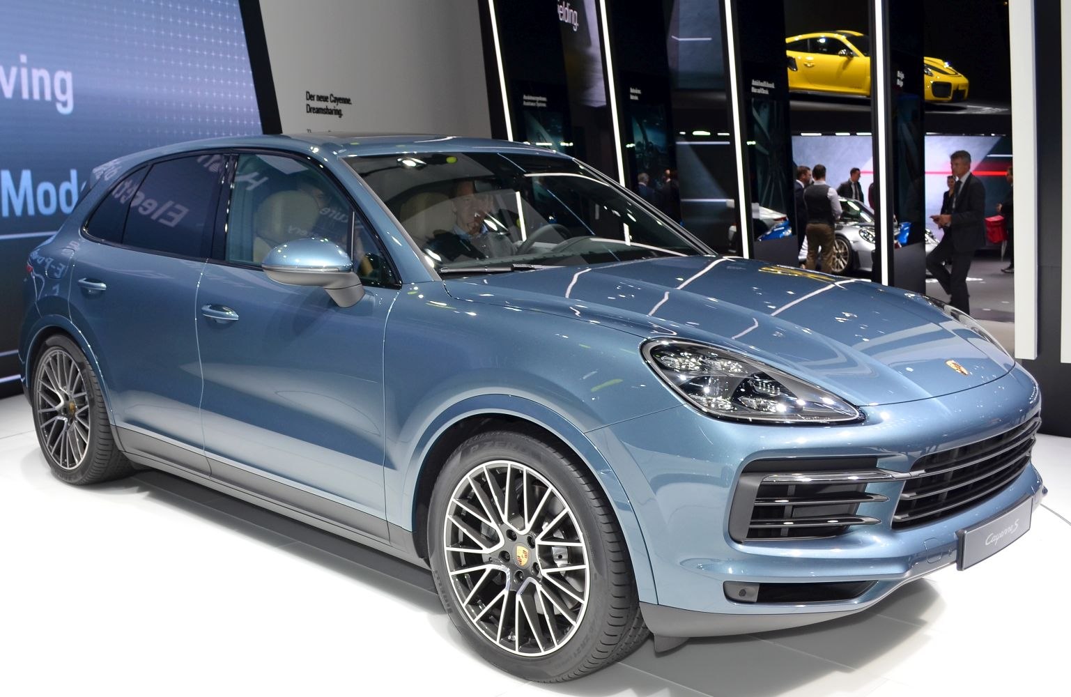 Front-side view of blue luxury SUV with LED headlights and alloy wheels