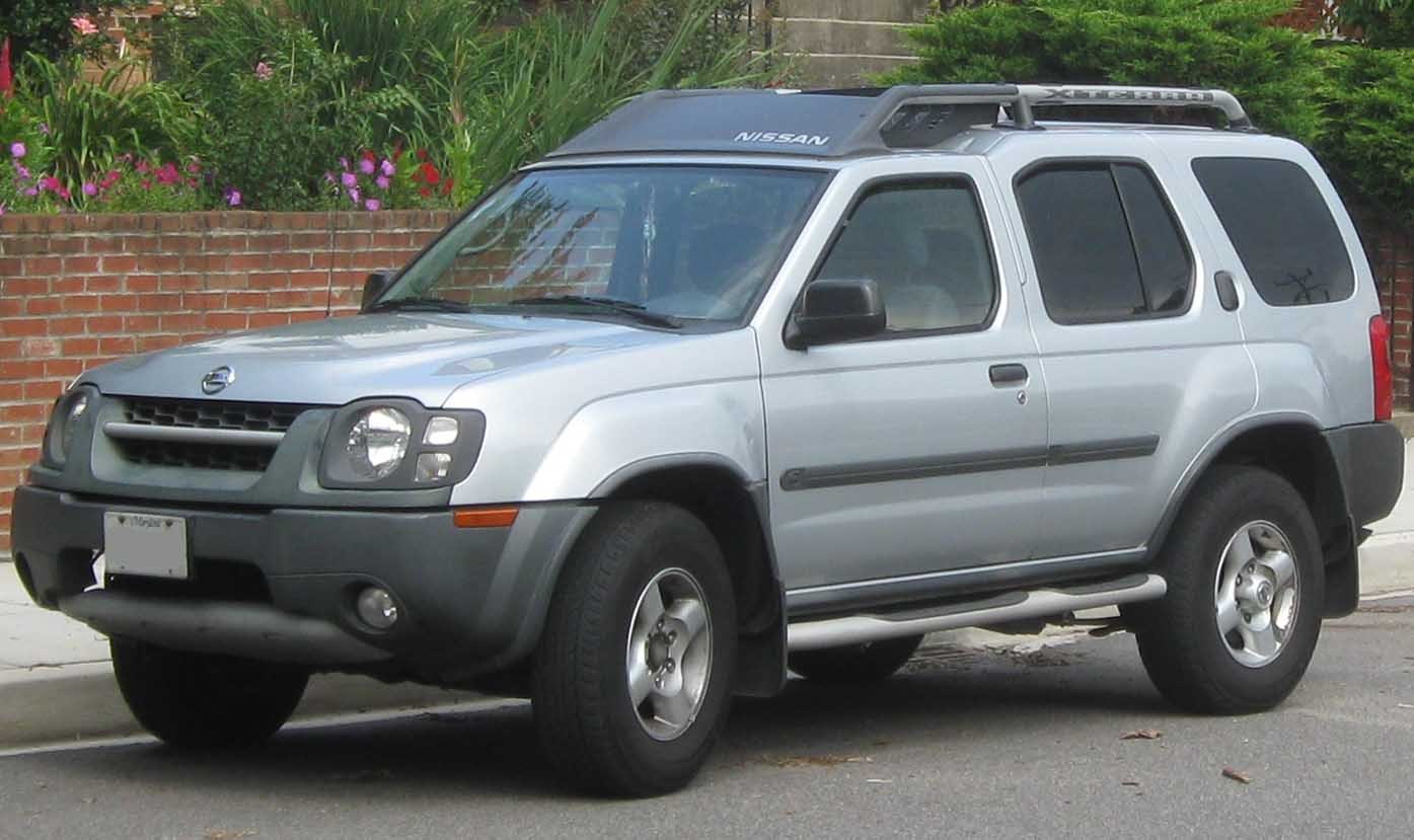 Silver SUV front side view with roof rack and unique headlight design