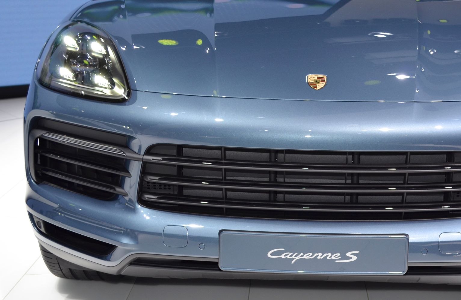 Front grille and LED headlight close-up with badge