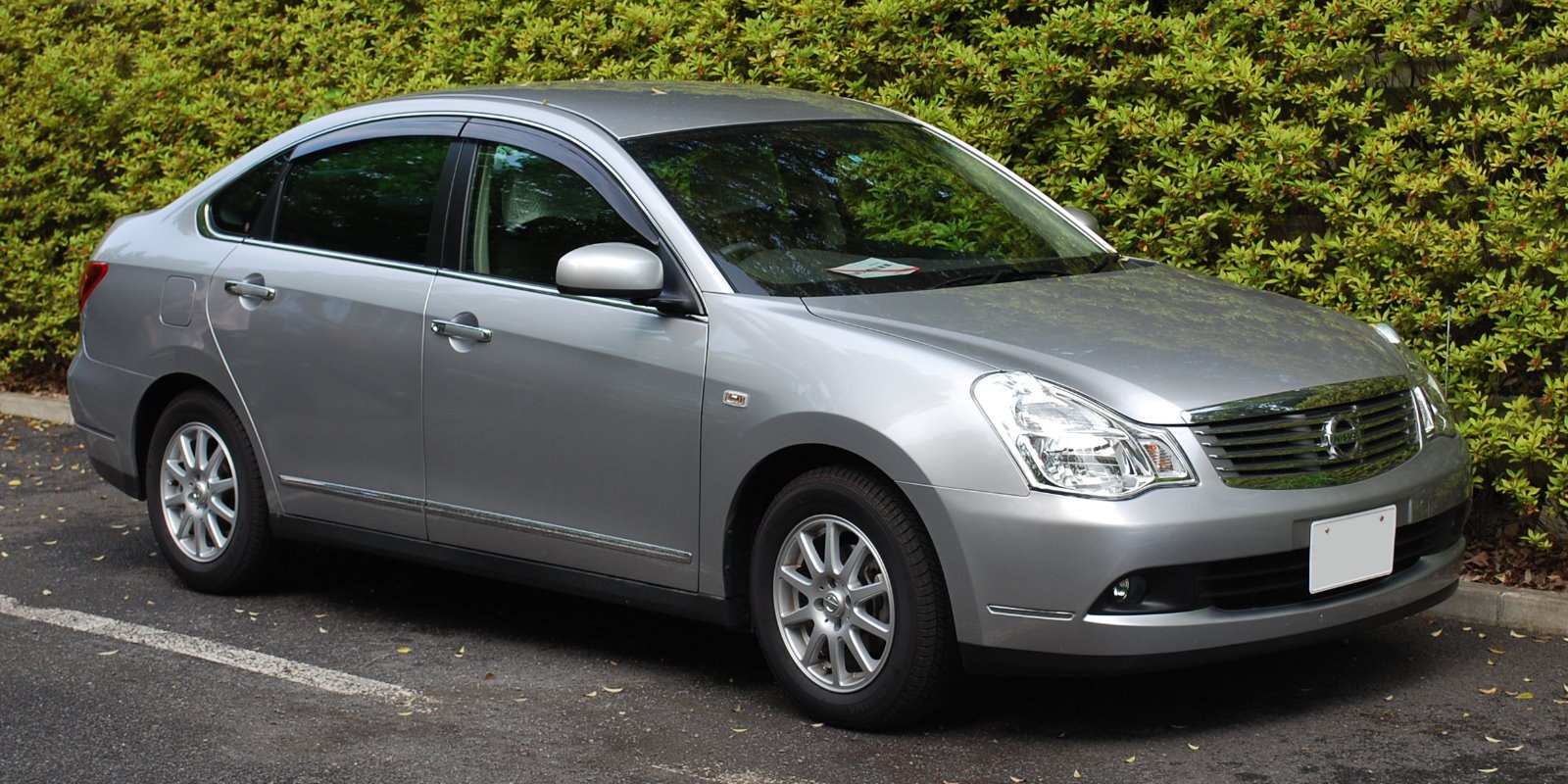Silver sedan with front side view, alloy wheels, and clear headlamps
