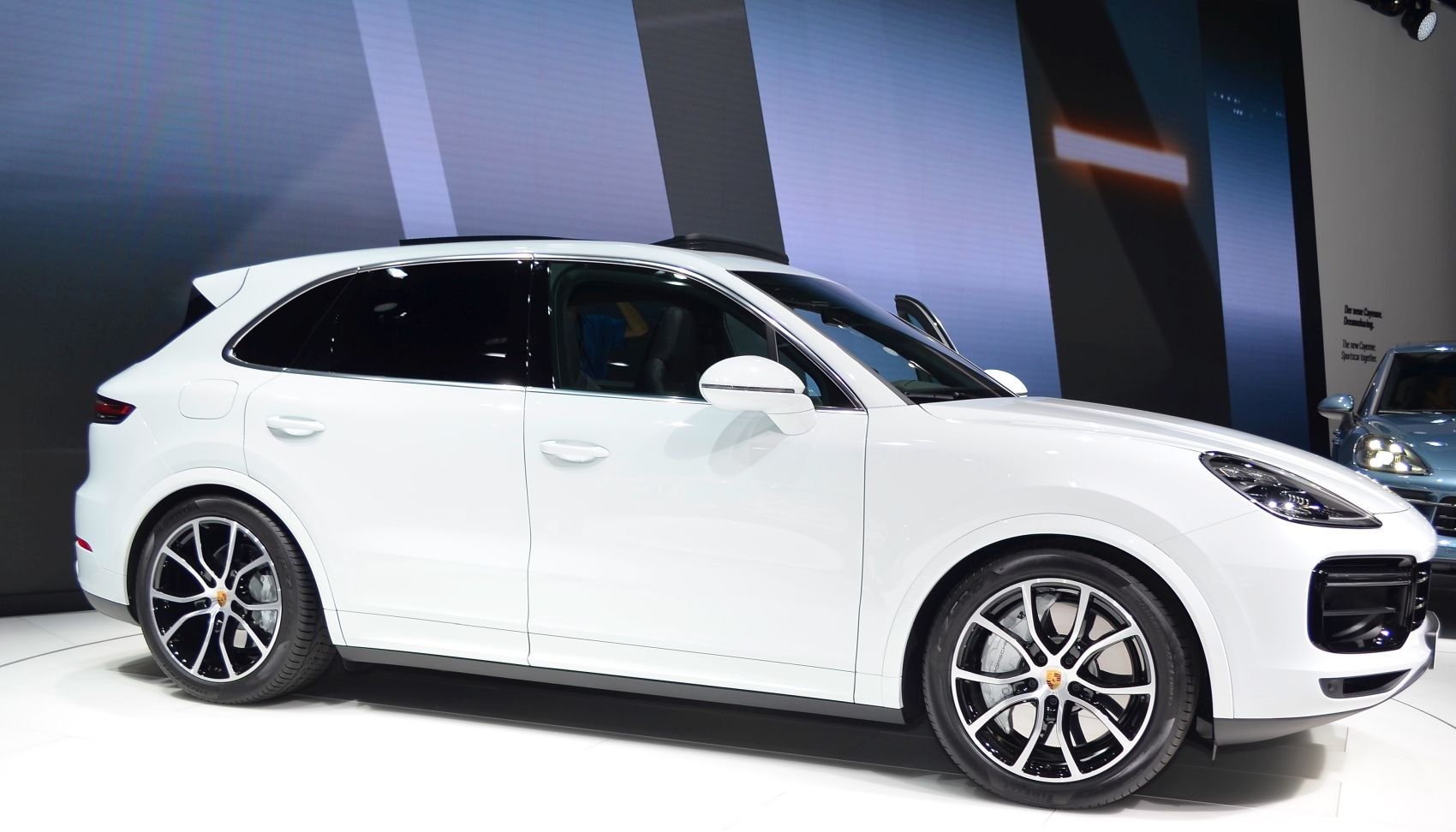 Side profile of white SUV with sporty alloy wheels