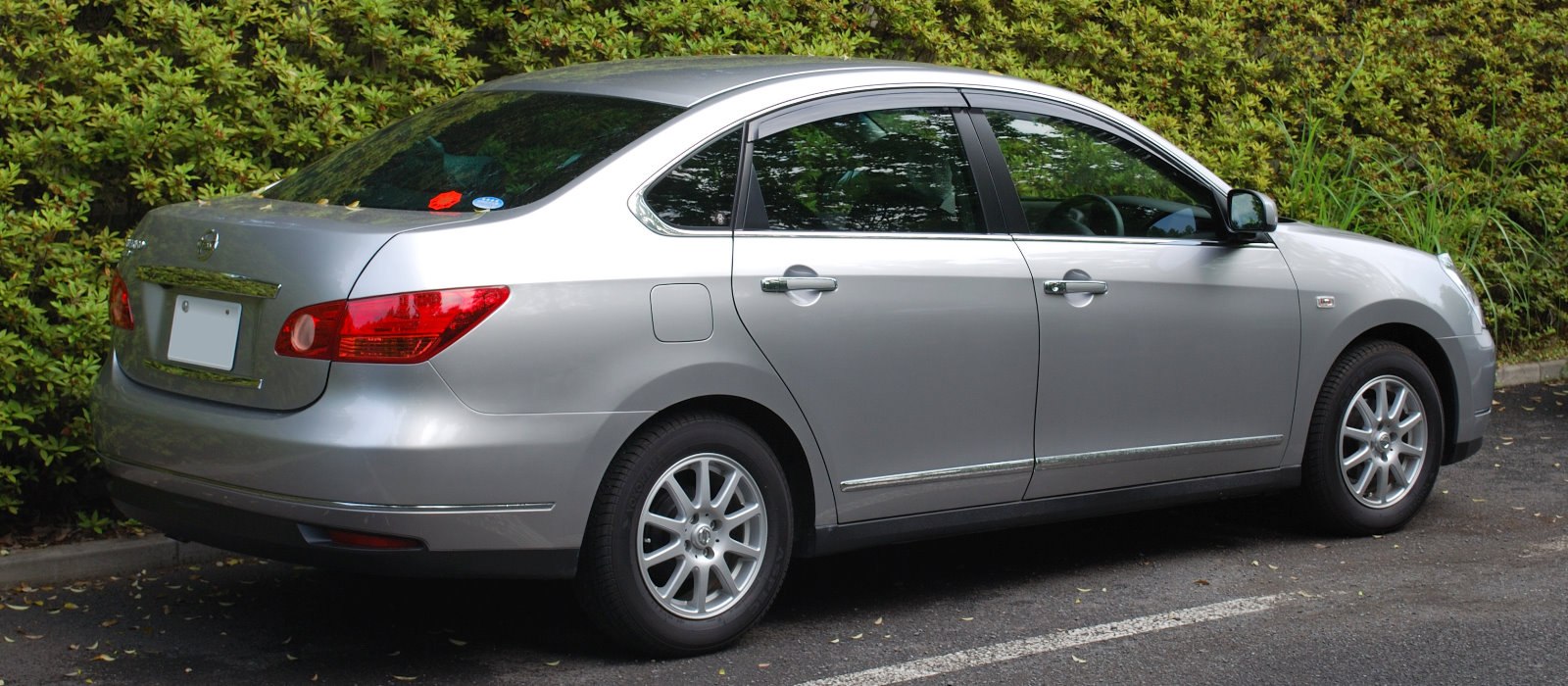 Rear side view of a mid-size sedan with alloy wheels and chrome trim