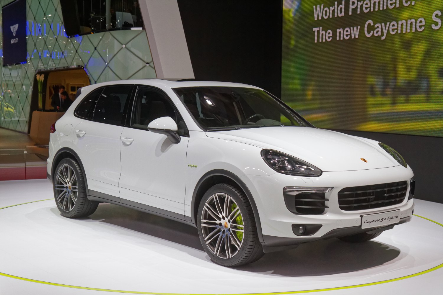 White luxury SUV with modern headlights and hybrid badge