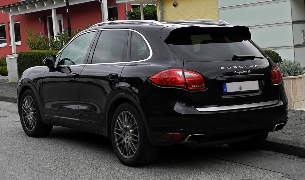 Rear view of a sporty luxury SUV with distinctive tail lights and dual exhausts.