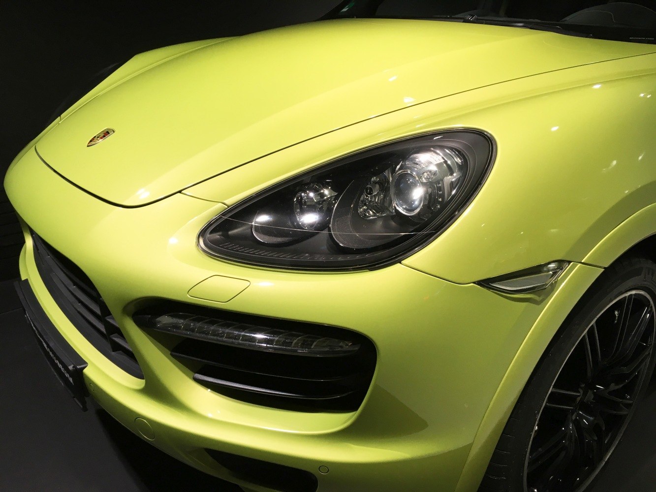Front headlight and grille close-up on lime green SUV
