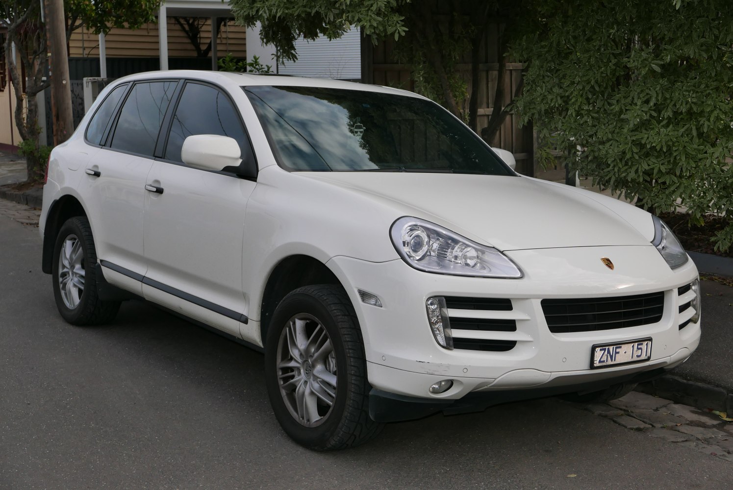 White SUV with oval headlights and horizontal grille bars