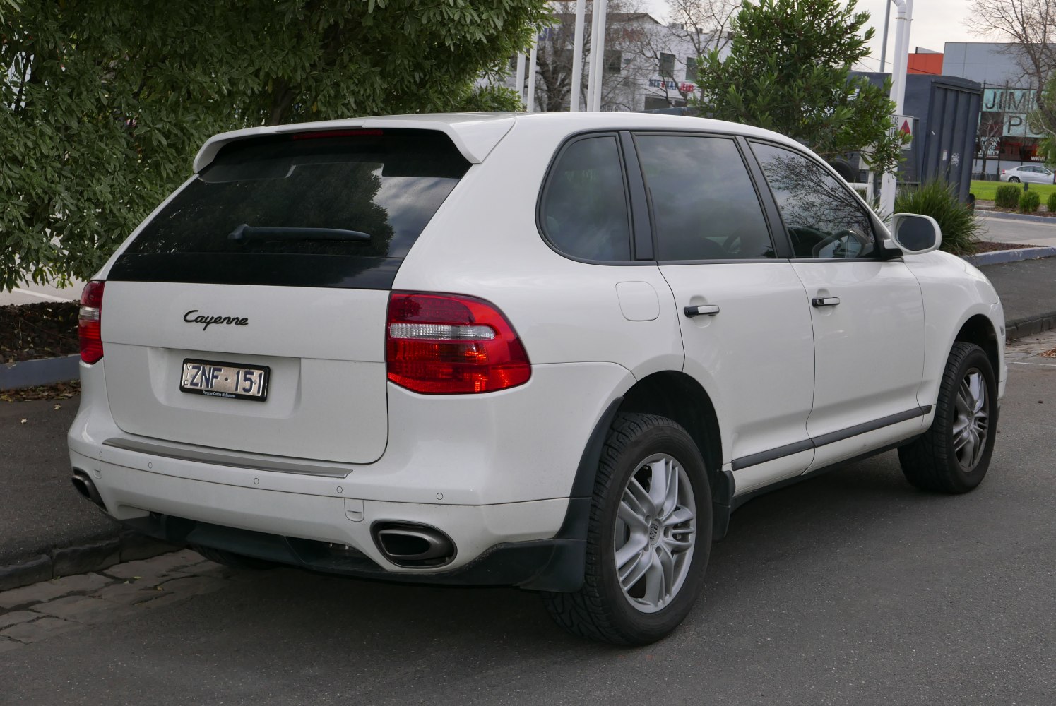 Rear view of SUV with tinted windows, dual exhaust, and distinct taillights