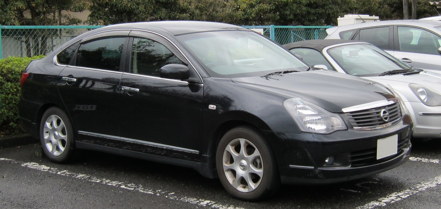 Black mid-size sedan with alloy wheels and detailed headlights