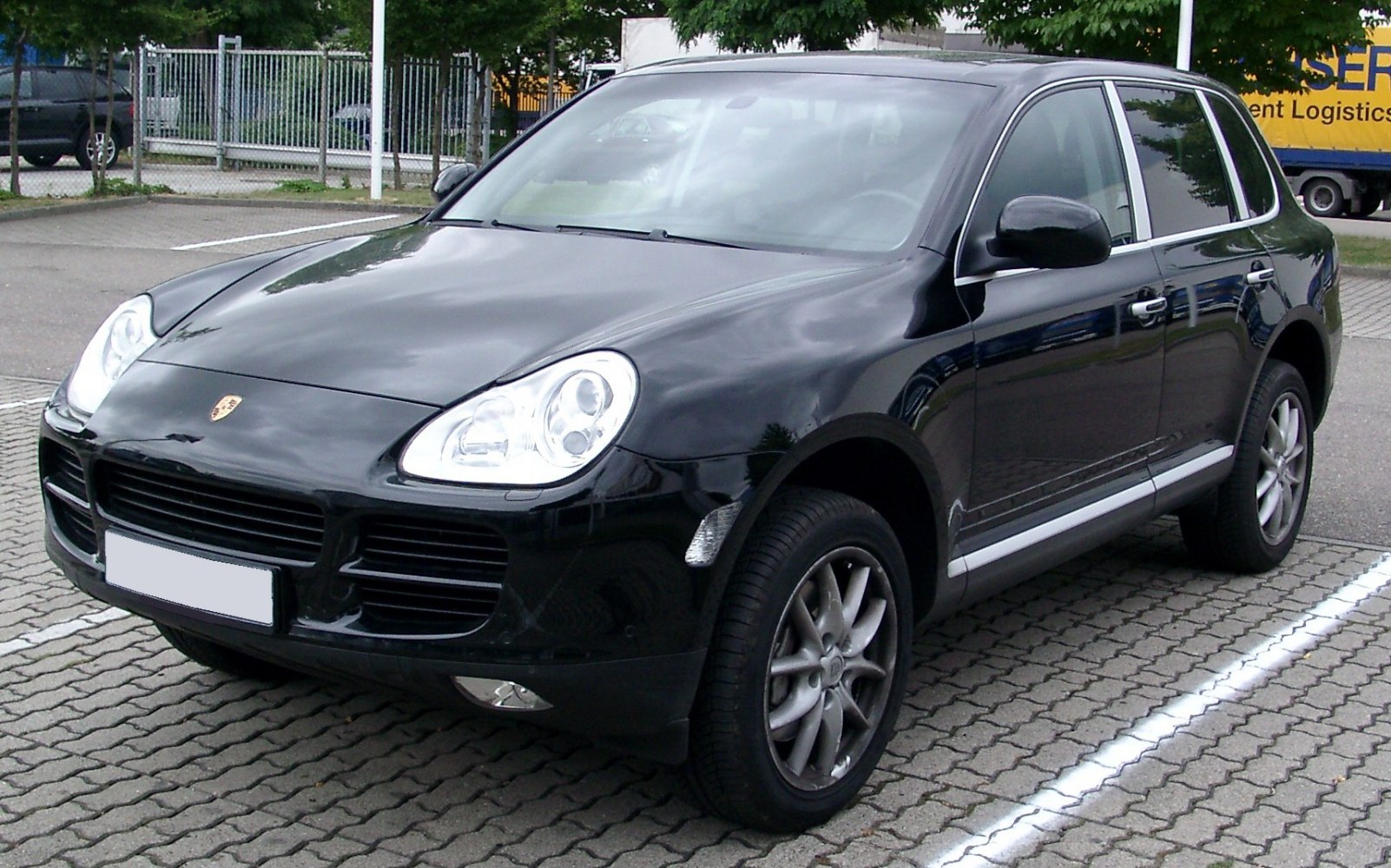 Front-side view of a luxury SUV with distinctive headlights and alloy wheels