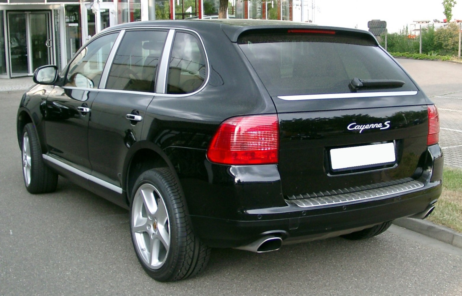 Rear view with tail lights and rear spoiler of a black SUV