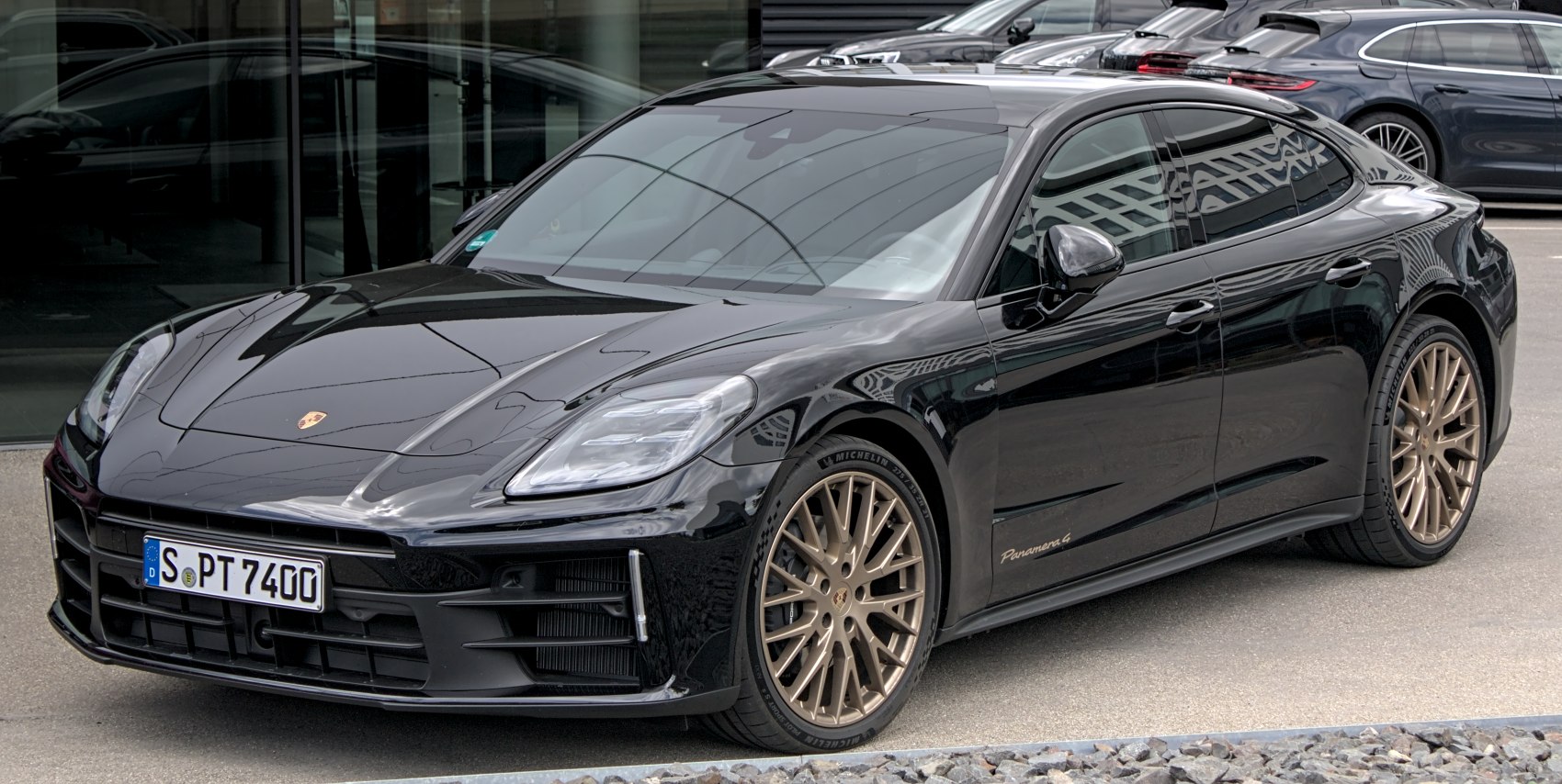 Aerodynamic luxury sports sedan with bold bronze alloy wheels