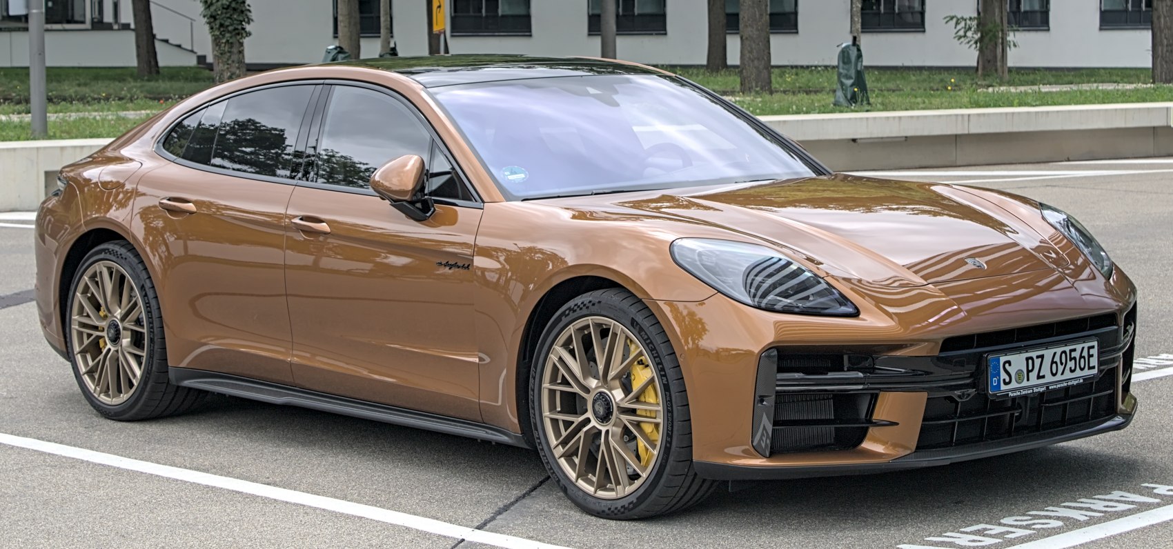 Bronze luxury sport sedan with alloy wheels and yellow brake calipers